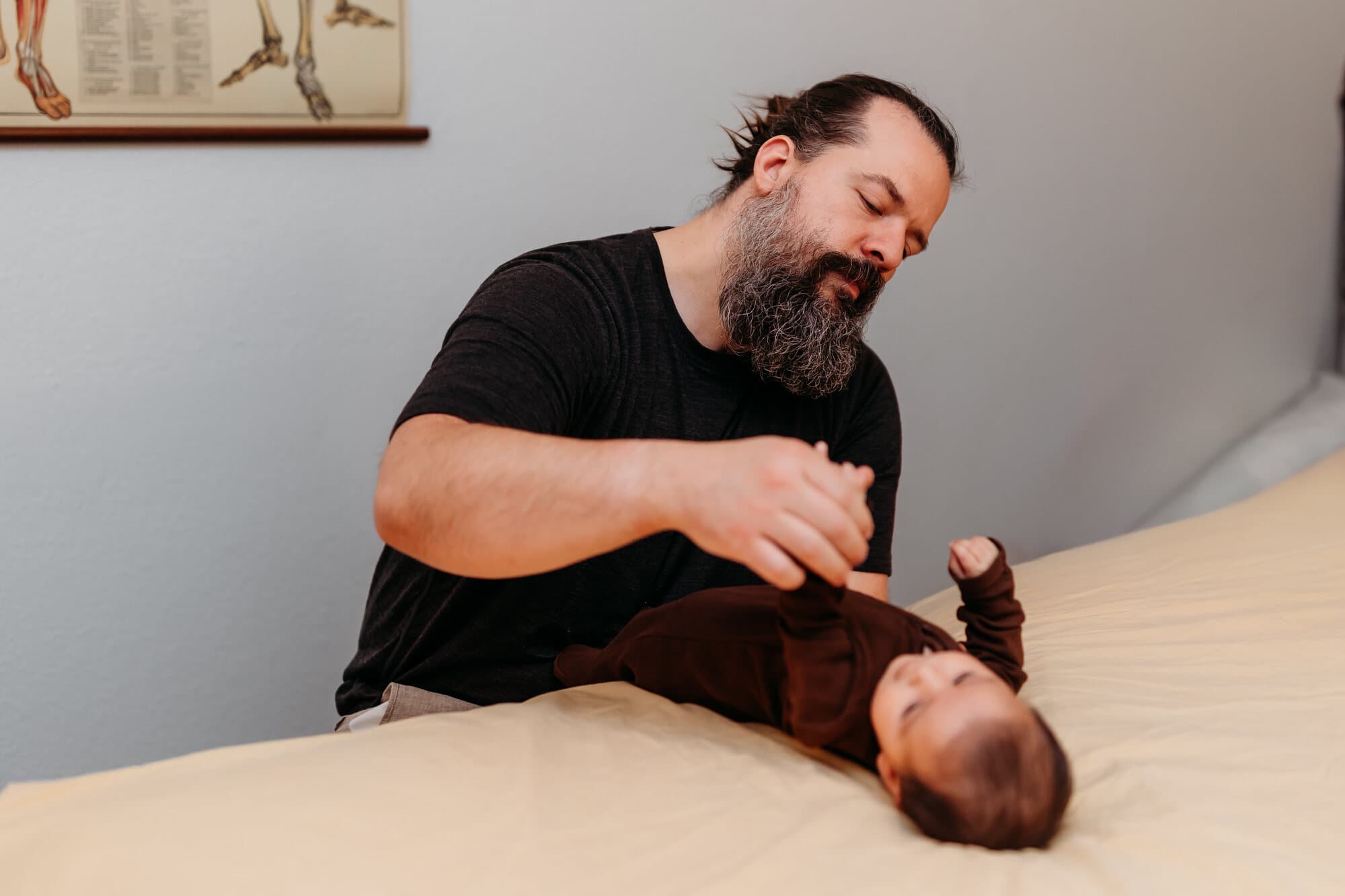 Jared Fitzgerald working with an infant on the treatment table at the Brighton practice
